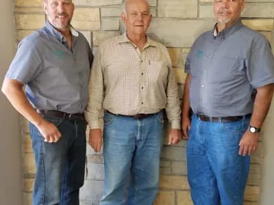 Three men smiling together for a photo