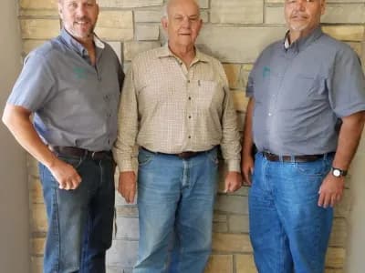 Three men smiling together for a photo