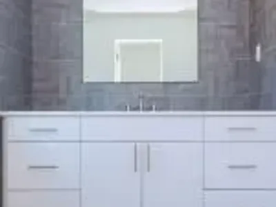 Grey stone pattern tiled contemporary bathroom interior design with minimal natural wood furniture details dominate neutral colors. Interior design of a bathroom restroom interior design