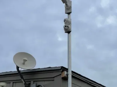 Outdoor surveillance camera system mounted on a building pole